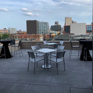 View of outdoor seating with Columbus skyline in background at The Terrace event venue.